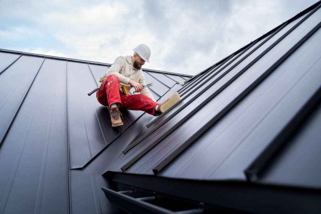 A full shot capturing a man engaged in work on a rooftop, providing a comprehensive view of his activities and the roofing materials and tools in use