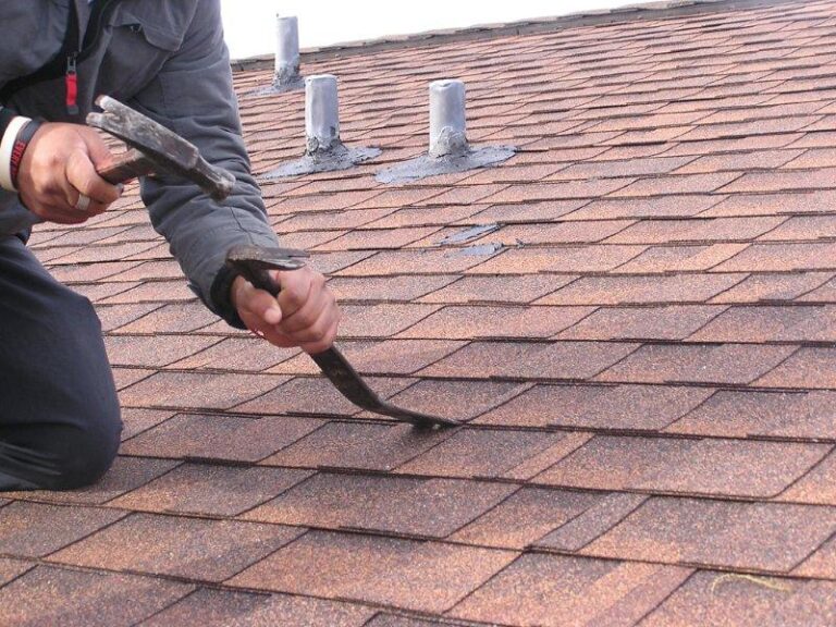 Roofer repairing roof