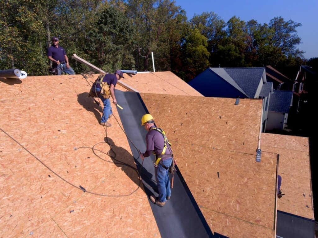 Roofers installing ice and water shield