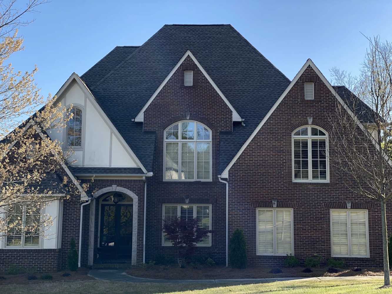 Completed roof replacement by Capstone Roofing on a luxury brick home in Mountain Brook Alabama